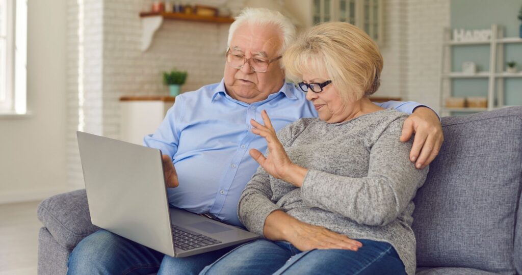 elderly couple video chatting on the computer