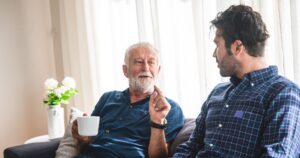 son and elderly father having a discussion