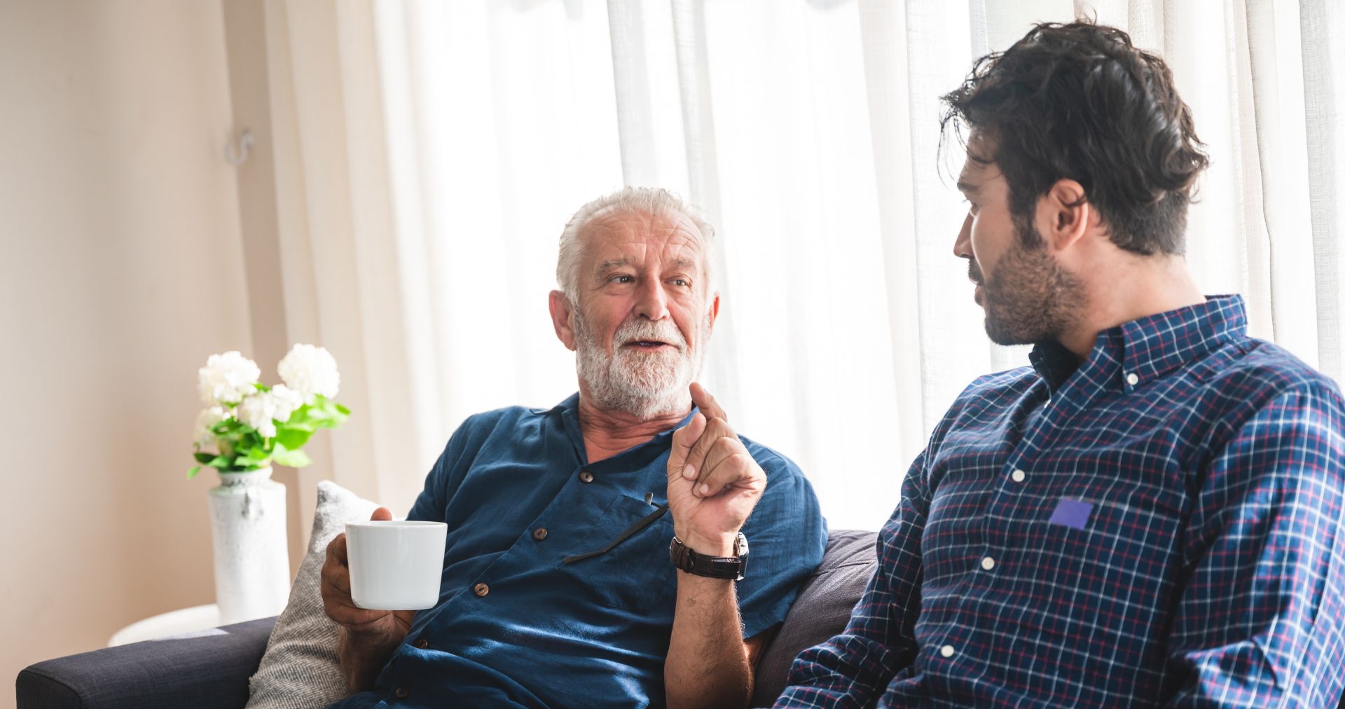 son and elderly father having a discussion